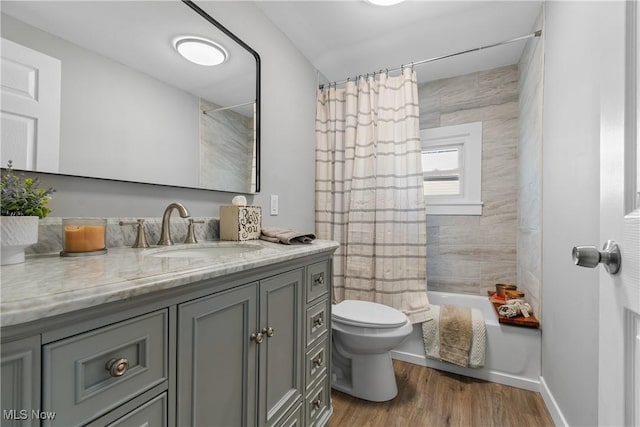 full bathroom featuring vanity, hardwood / wood-style flooring, toilet, and shower / bath combo