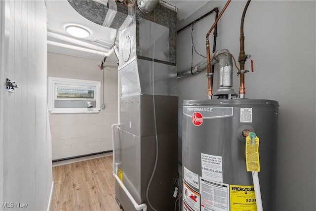 utility room featuring water heater and heating unit