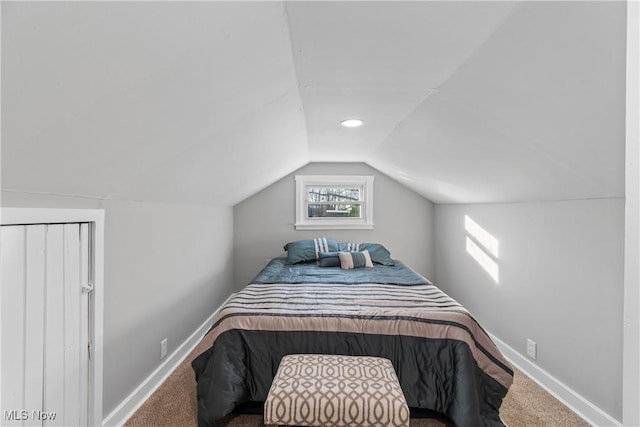 bedroom with lofted ceiling and carpet