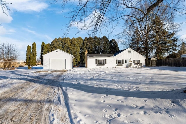 single story home featuring a garage and an outdoor structure