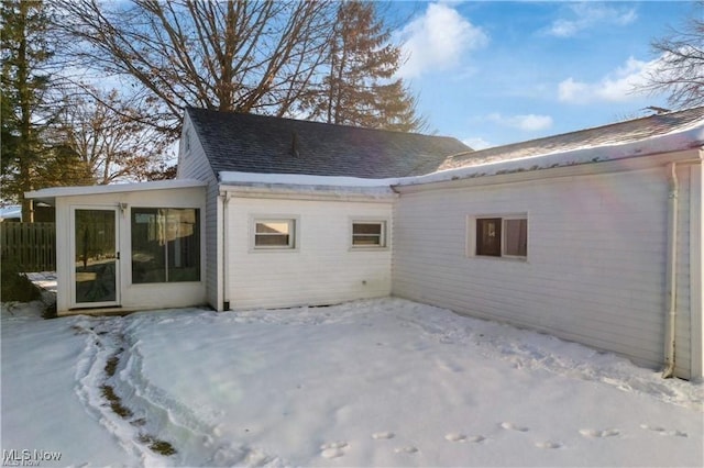 view of snow covered back of property