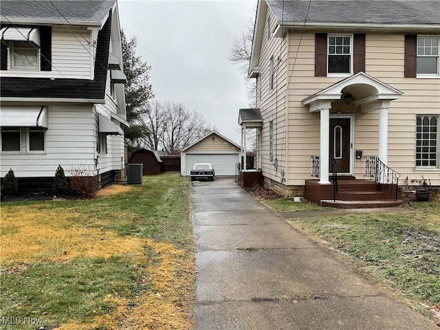 view of side of home featuring a garage, central AC, an outbuilding, and a lawn