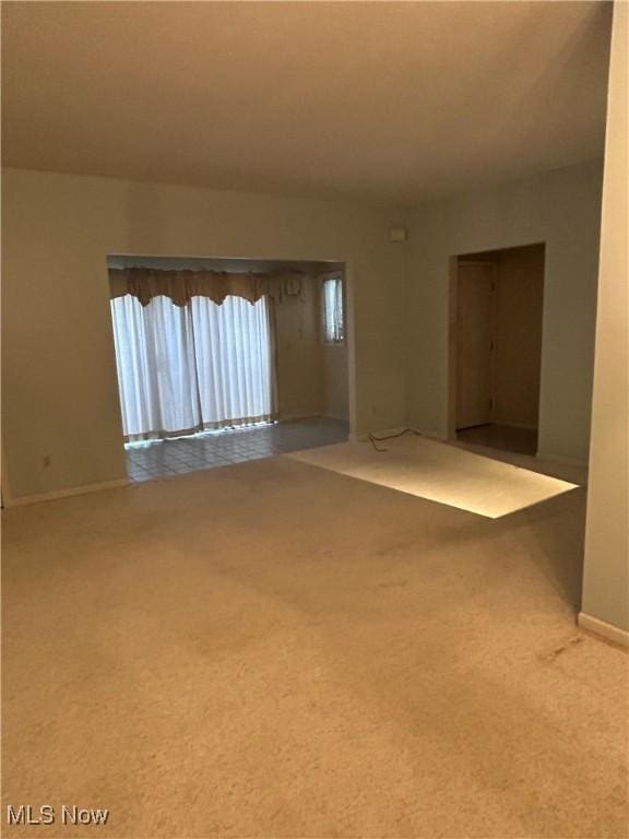 unfurnished room featuring carpet