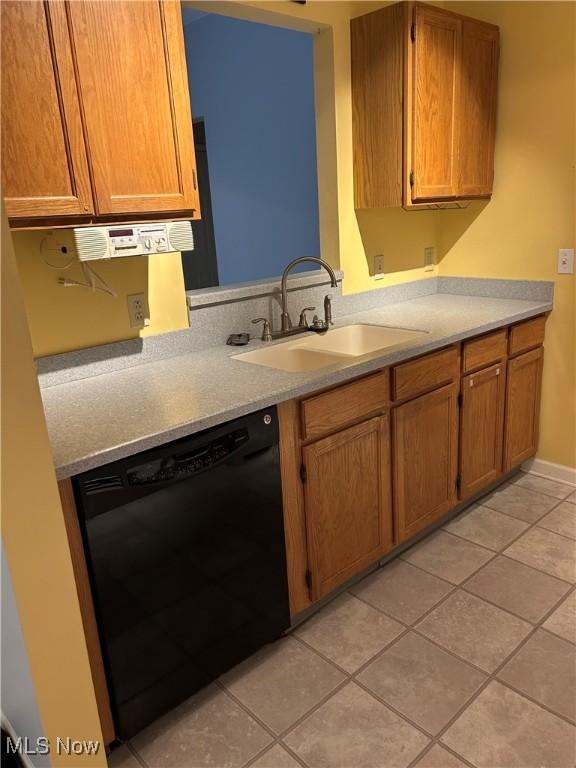 kitchen with dishwasher, sink, and light tile patterned floors