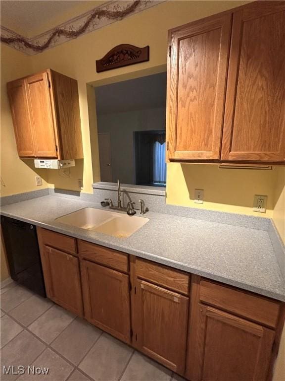 kitchen with sink, light tile patterned floors, and dishwasher