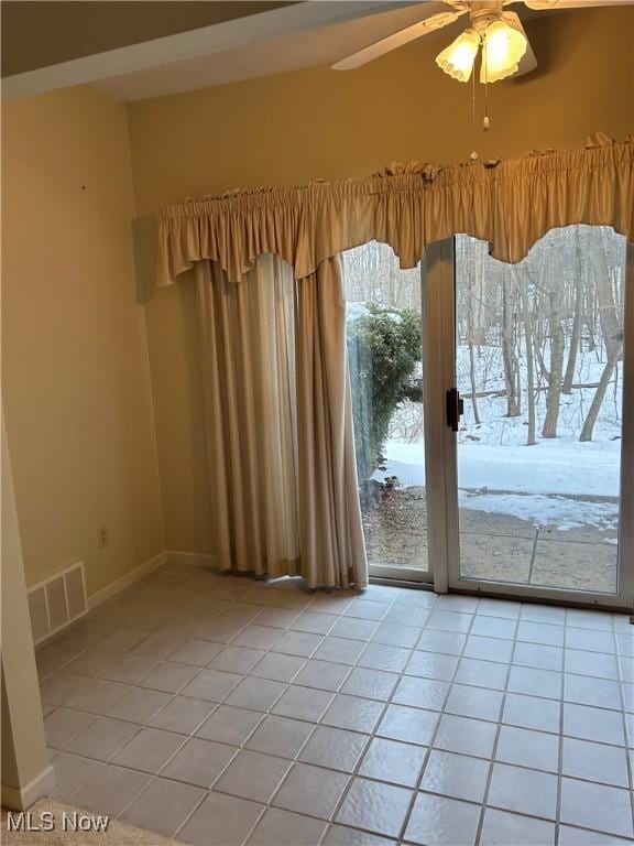 interior space featuring light tile patterned floors and ceiling fan