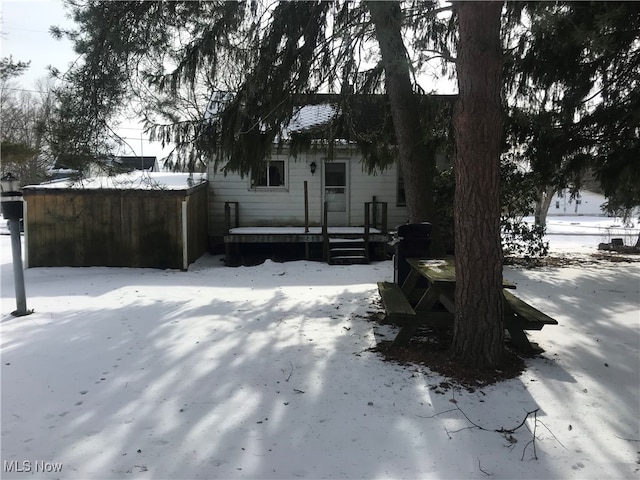 snowy yard featuring a deck