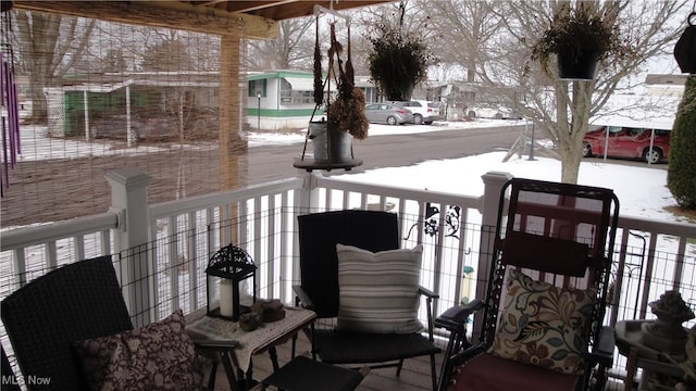 view of snow covered back of property