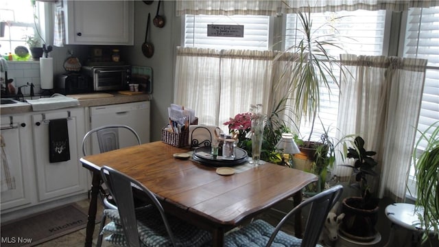 dining space featuring washer / clothes dryer and sink