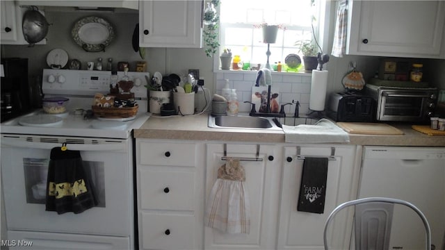 13 Cherokee, Creston, OH 44217 - kitchen with a sink, backsplash, white cabinetry, white appliances, and light countertops