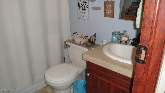 bathroom with tile patterned flooring, vanity, and toilet