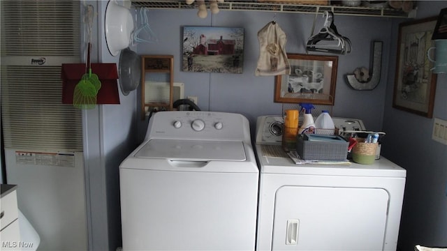 clothes washing area featuring independent washer and dryer