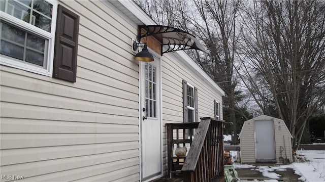 13 Cherokee, Creston, OH 44217 - view of snow covered exterior featuring an outbuilding and a storage unit