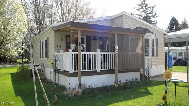 13 Cherokee, Creston, OH 44217 - view of front facade featuring covered porch and a front yard