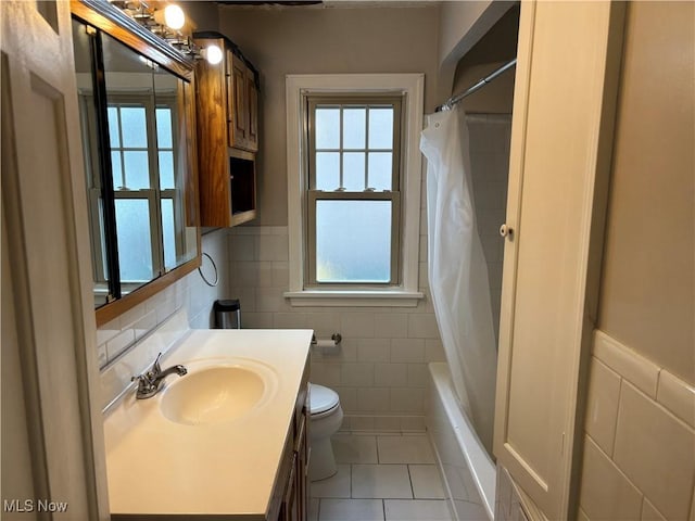 full bathroom featuring tile walls, vanity, tile patterned flooring, and toilet