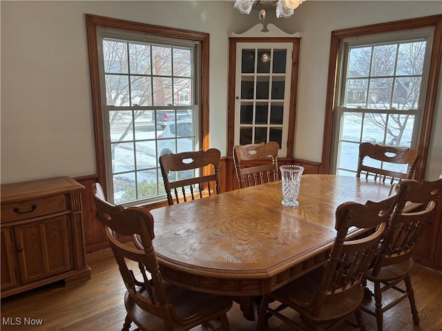 dining area with plenty of natural light and hardwood / wood-style floors