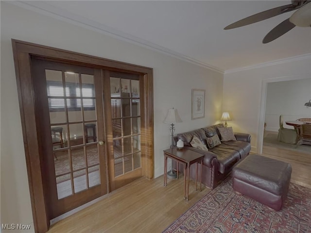 living room featuring french doors, ceiling fan, ornamental molding, and light hardwood / wood-style flooring