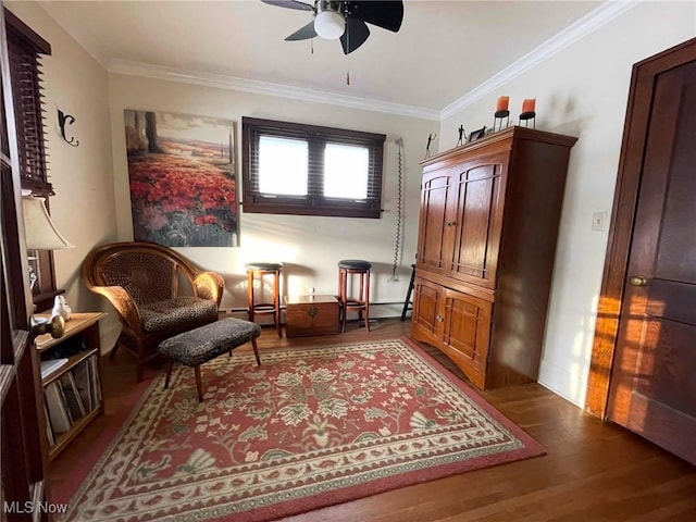 sitting room with crown molding, ceiling fan, and dark hardwood / wood-style flooring