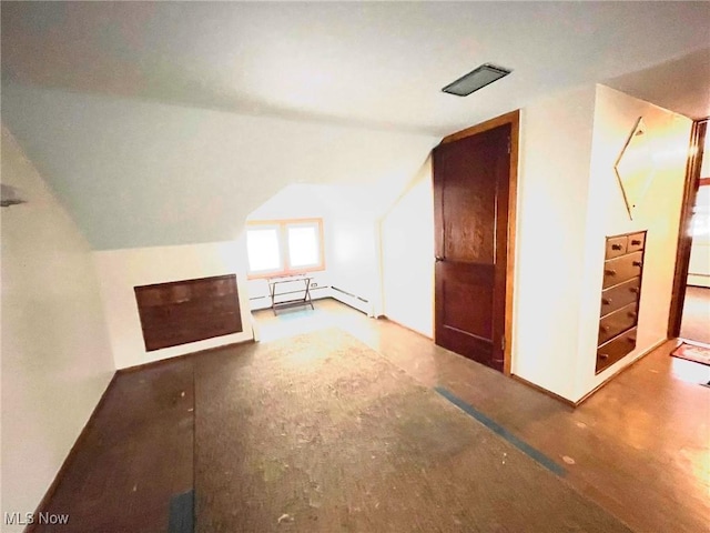 additional living space featuring a baseboard radiator and lofted ceiling