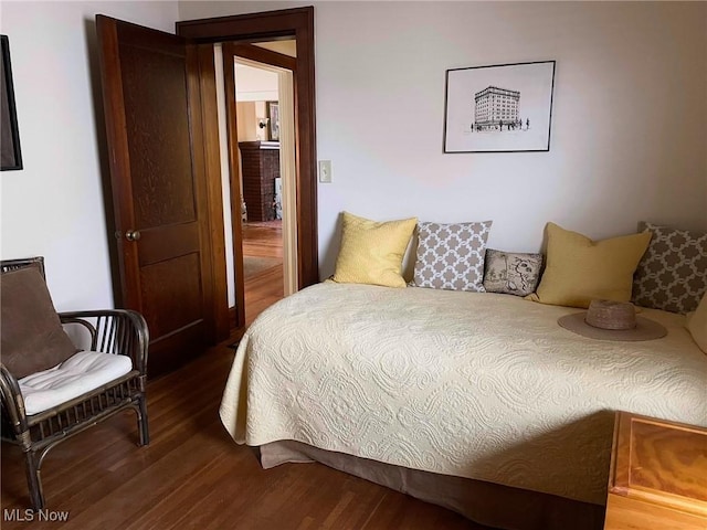 bedroom with dark wood-type flooring