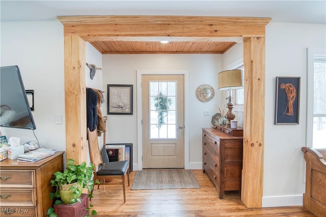 entrance foyer with wood ceiling and light hardwood / wood-style flooring