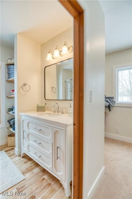 bathroom featuring hardwood / wood-style flooring and vanity