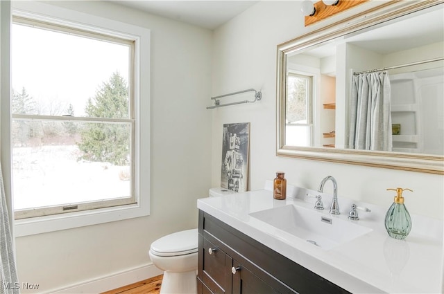 bathroom with a shower with curtain, vanity, hardwood / wood-style floors, and toilet