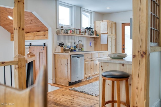 kitchen with sink, light brown cabinets, dishwasher, and light wood-type flooring