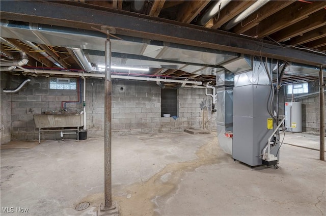 basement featuring heating unit, sink, and gas water heater