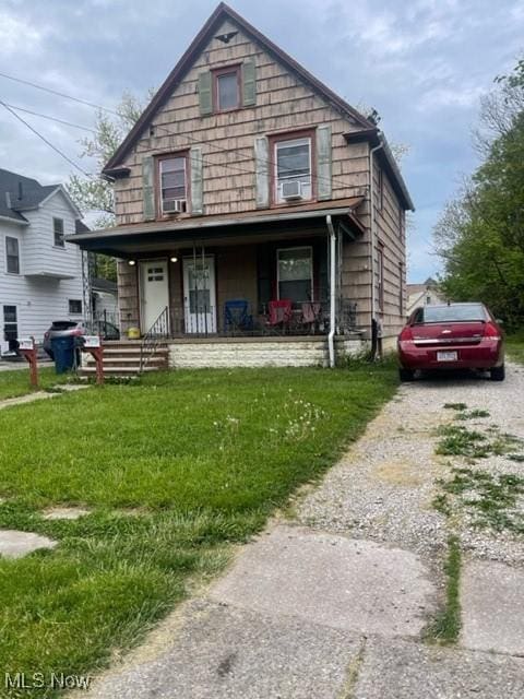 view of front of home with a front yard and covered porch