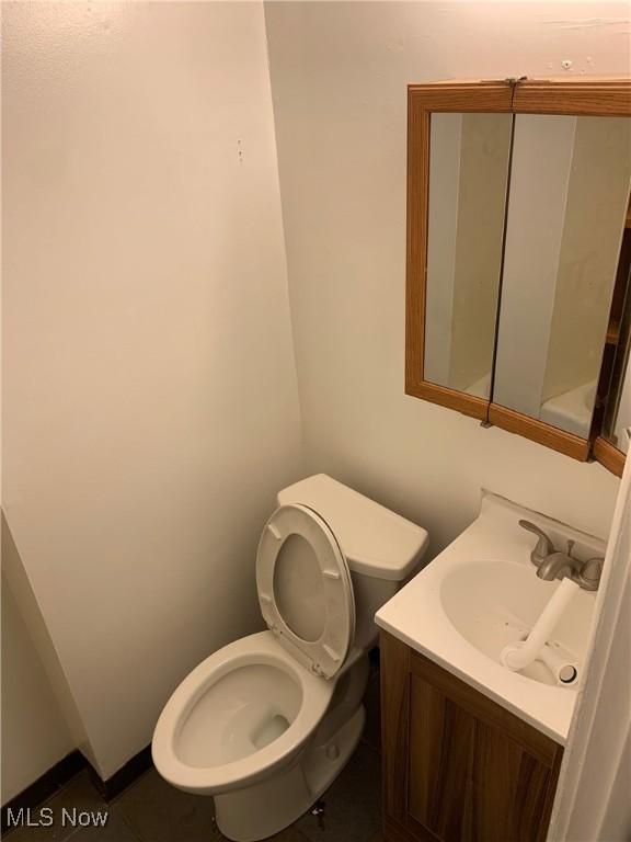 bathroom featuring toilet and vanity