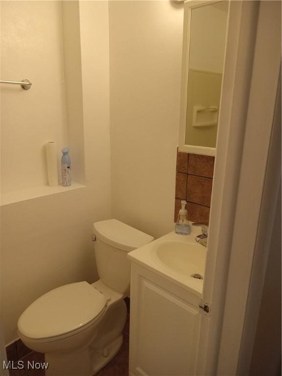 bathroom featuring toilet and vanity