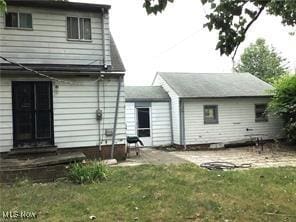 back of house with a yard and a patio area