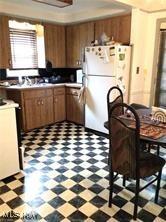 kitchen with white refrigerator and range