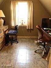 office with tile patterned flooring and vaulted ceiling