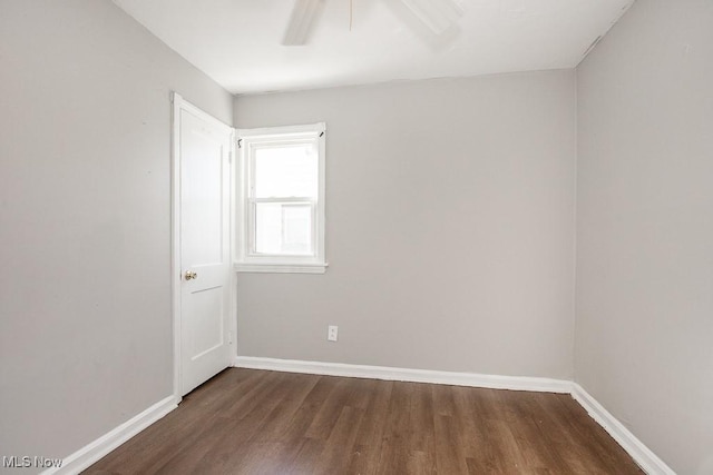 empty room with dark wood-type flooring and ceiling fan