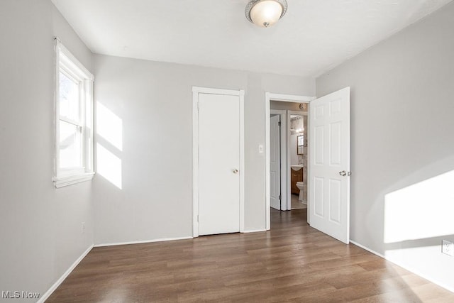 unfurnished room with dark wood-type flooring