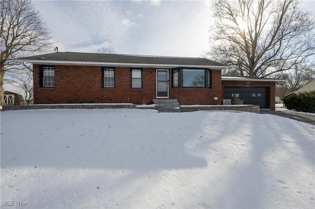 view of front of property with a garage and central air condition unit