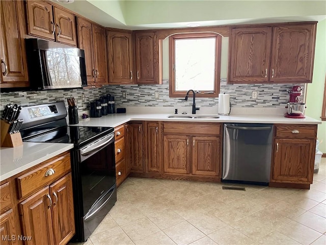 kitchen with sink, electric range oven, light tile patterned floors, dishwasher, and backsplash