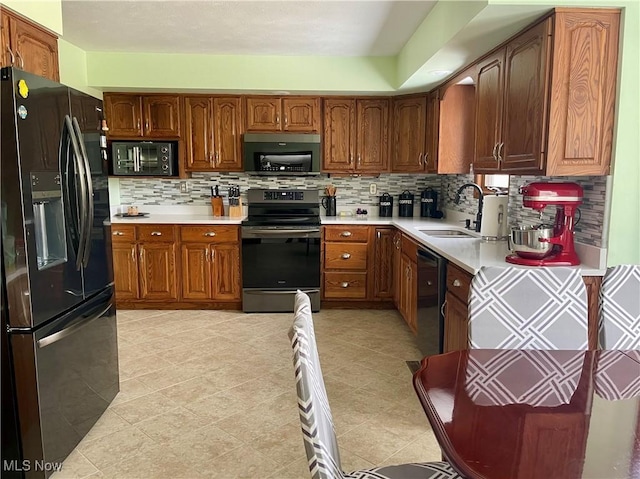 kitchen featuring tasteful backsplash, sink, and black appliances