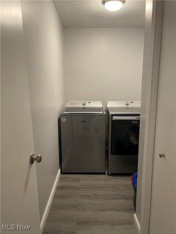 laundry area featuring dark hardwood / wood-style floors and washer and dryer