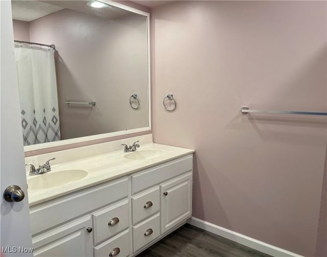 bathroom with hardwood / wood-style flooring, vanity, and a shower with shower curtain