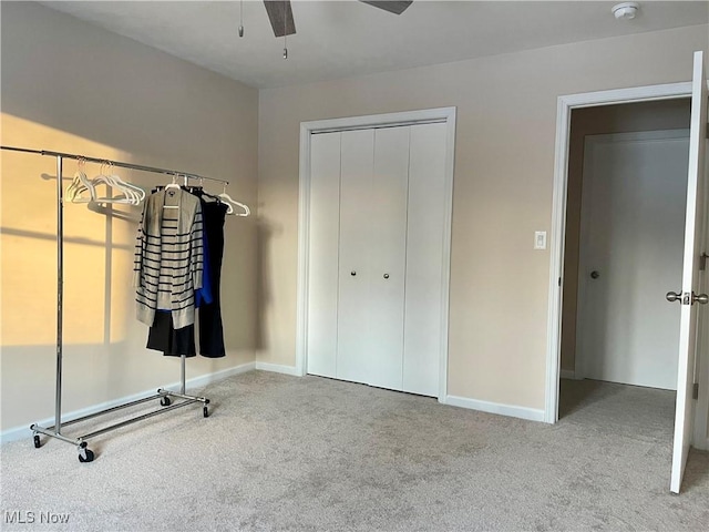 unfurnished bedroom featuring carpet, ceiling fan, and a closet