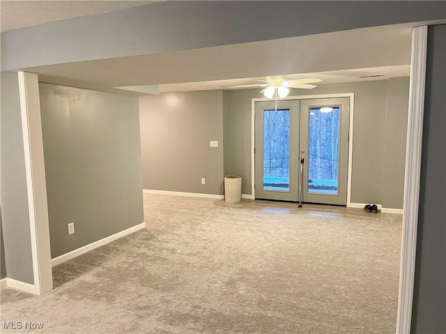 empty room featuring light colored carpet, ceiling fan, and french doors