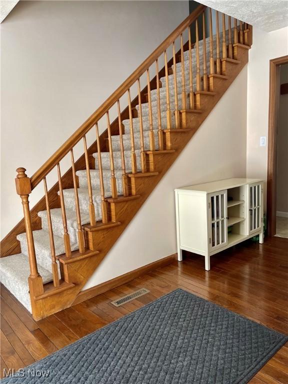 stairway featuring wood-type flooring