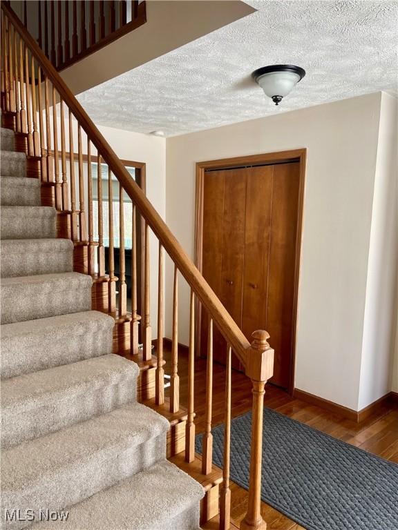 stairs featuring hardwood / wood-style flooring