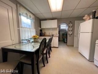 dining area featuring a paneled ceiling