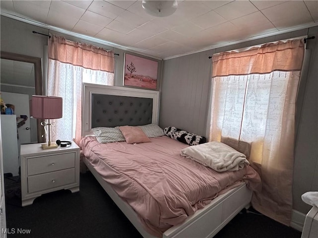 carpeted bedroom featuring crown molding