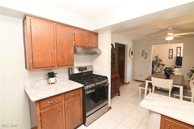 kitchen with stainless steel gas range oven and ceiling fan