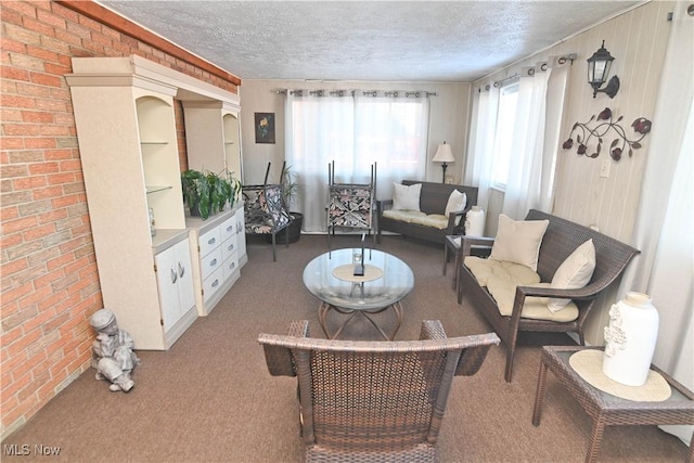 carpeted living room with a textured ceiling and wood walls